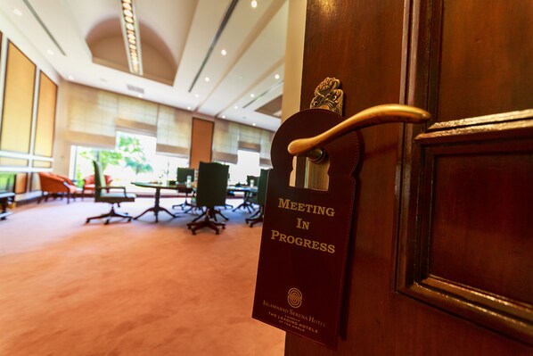 A door with a sign reading "Meeting in Progress" at the Islamabad Serena Hotel. - Islamabad Serena Hotel (Islamabad)
