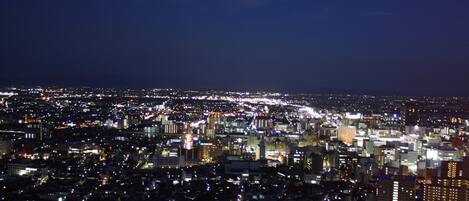 A nighttime cityscape with dense urban lighting.
