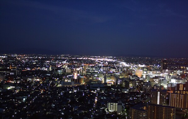 A nighttime cityscape with dense urban lighting.