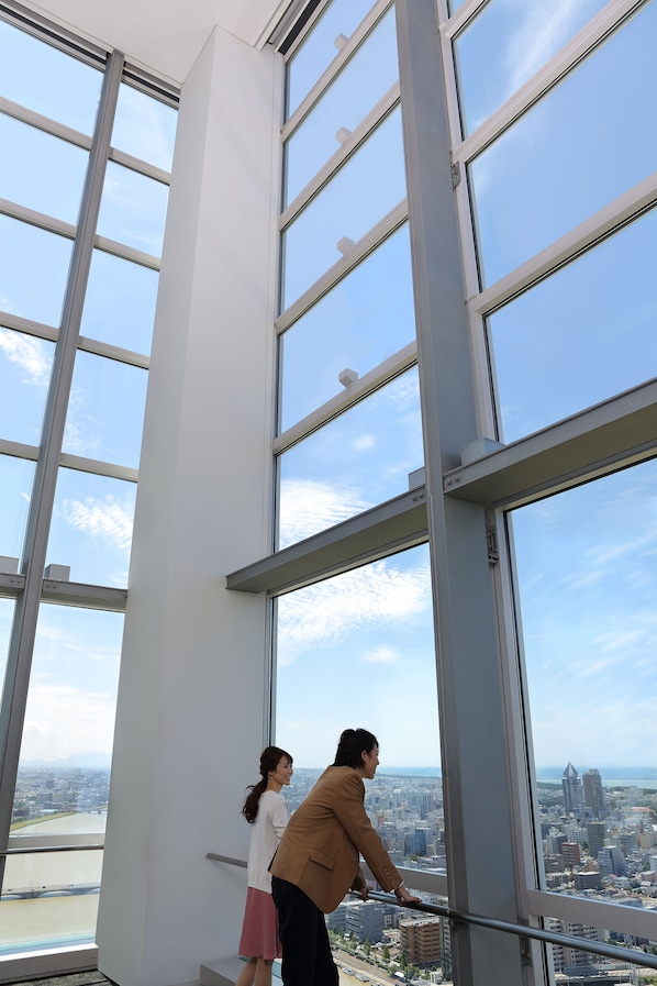 A high-rise building with large windows offering a city view.
