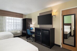 Premium bedding, desk, laptop workspace, blackout drapes
