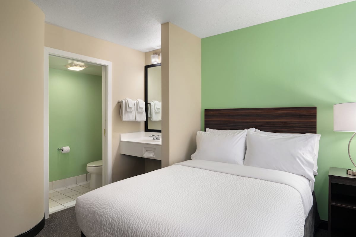 Premium bedding, desk, laptop workspace, blackout curtains