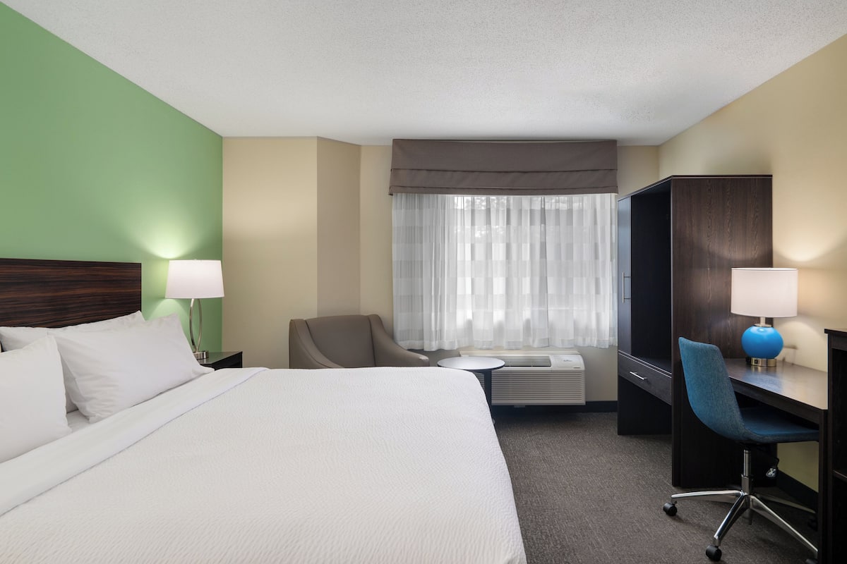 Premium bedding, desk, laptop workspace, blackout curtains