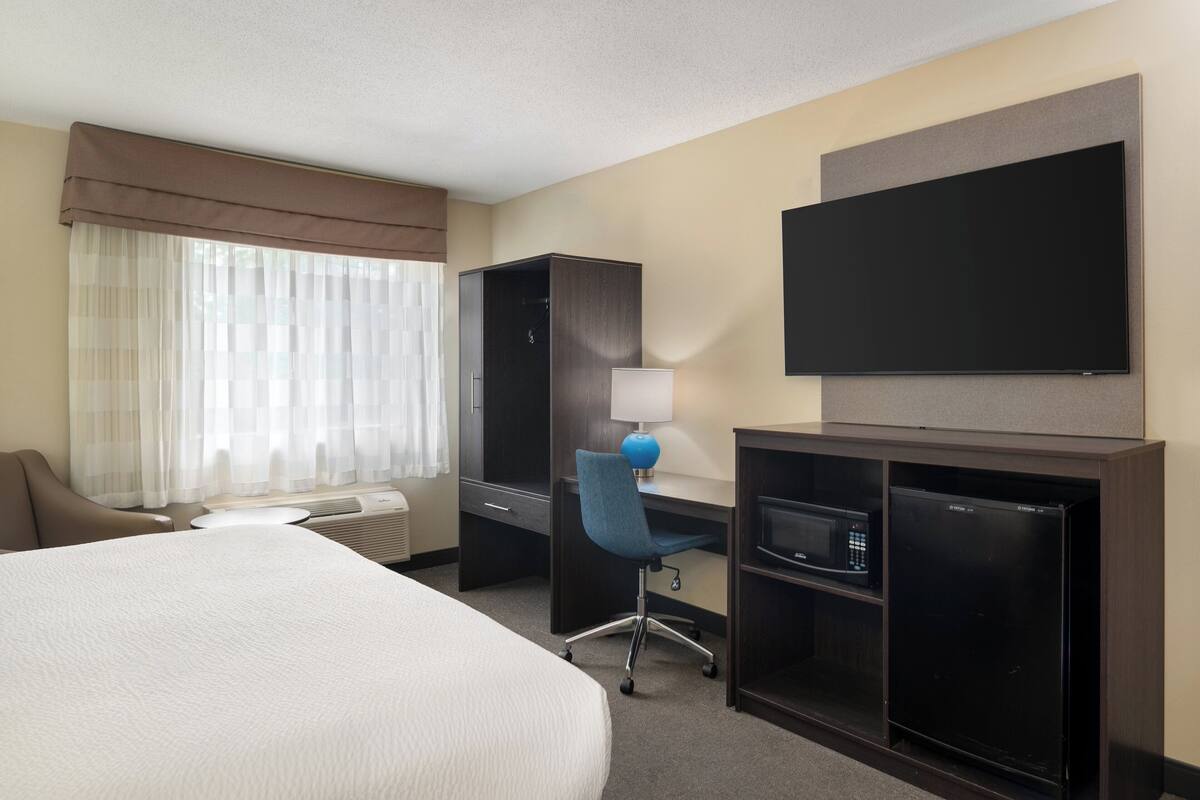 premium bedding, desk, laptop workspace, blackout curtains