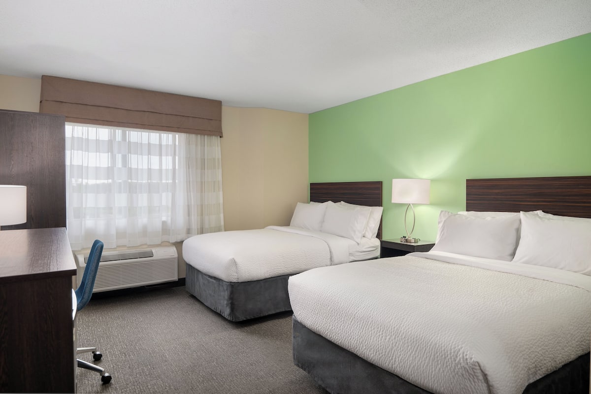 Premium bedding, desk, laptop workspace, blackout curtains