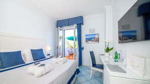 A hotel room with a bed, a desk, a chair, a laptop, and a view of the outdoors. - Hotel Villa Durrueli Resort & Spa (Ischia)
