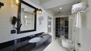 Designer toiletries, hair dryer, slippers, towels