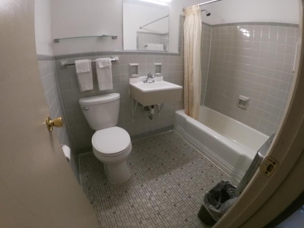 Un baño con inodoro, lavamanos y bañera.