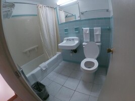 A bathroom with a bathtub, a sink, and a toilet.