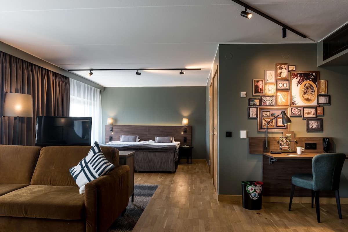 junior suite | in-room safe, desk, blackout curtains, iron/ironing board