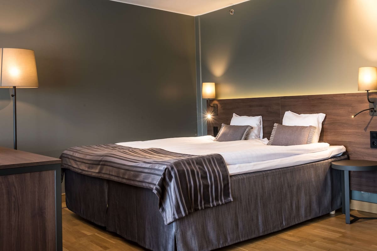 junior suite | in-room safe, desk, blackout curtains, iron/ironing board