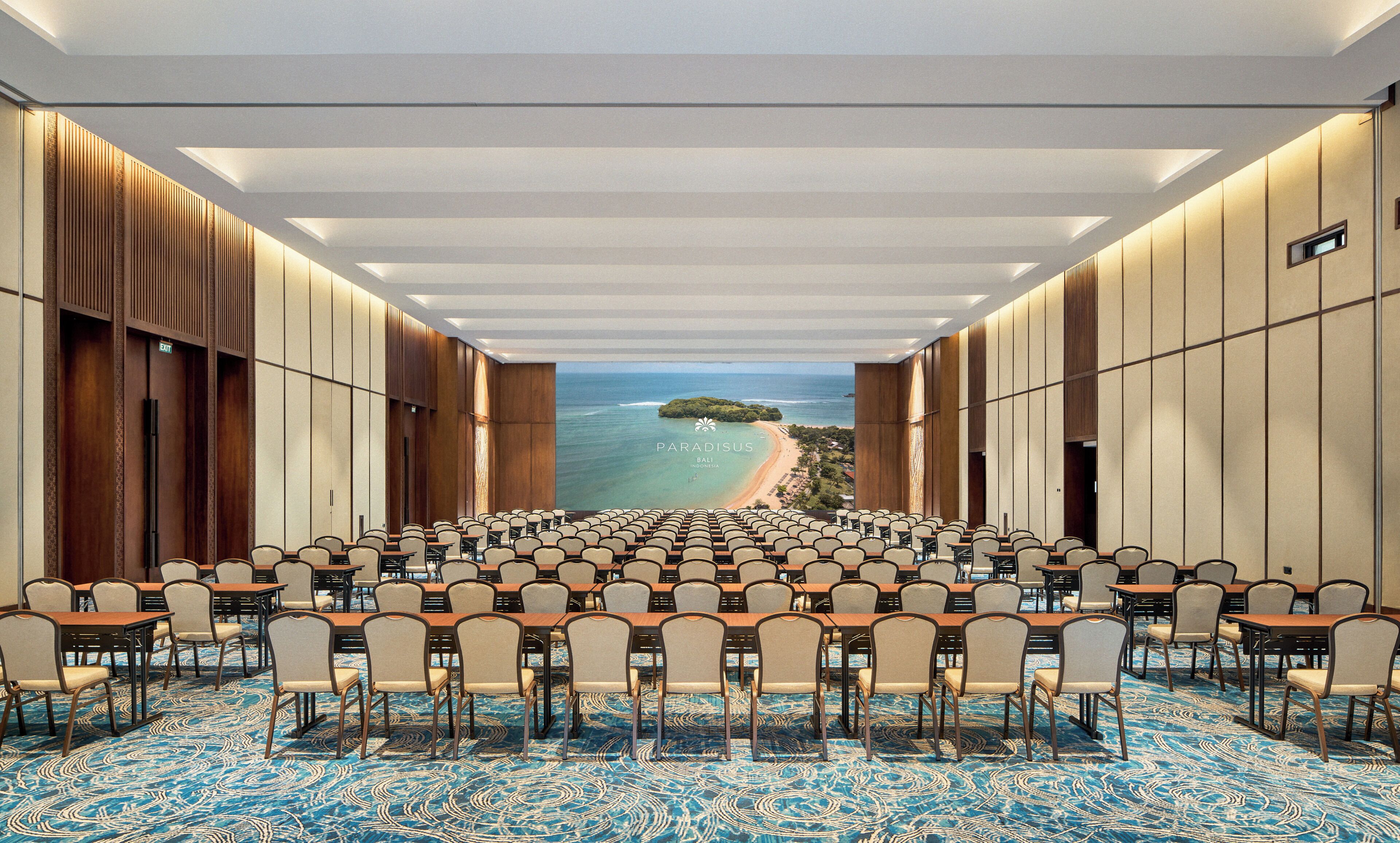 A conference room with a view of a beach and ocean.