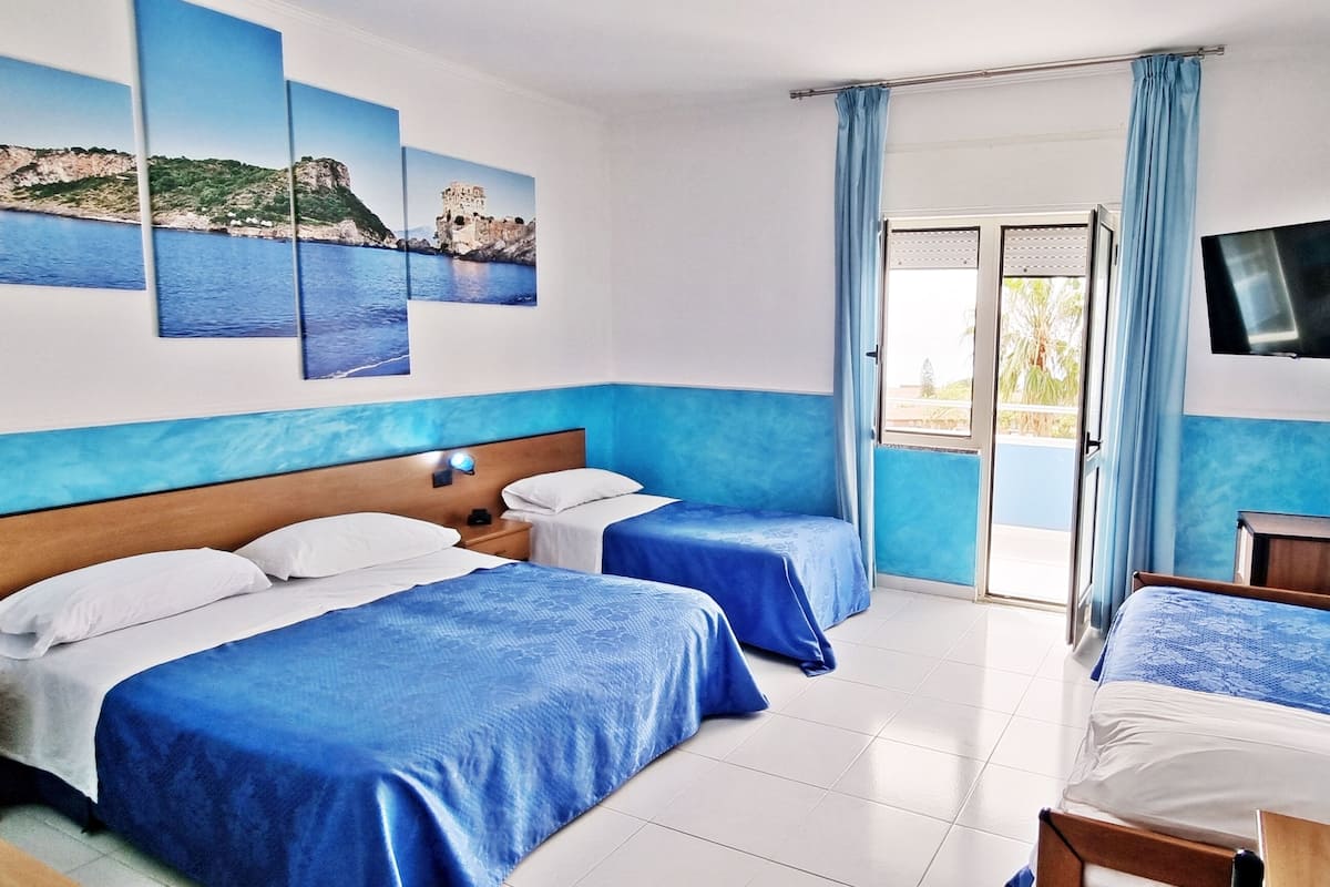 Kamar Quadruple Junior, pemandangan laut | Minibar, meja kerja, dan ruang kerja ramah laptop
