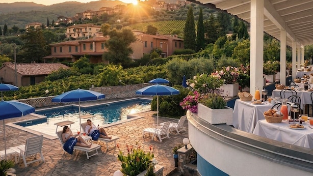 A poolside area with lounge chairs, umbrellas, and a table with breakfast items. - Hotel Blu Eden - Calabria oltre il Mare - Adults Only (Praia a Mare)