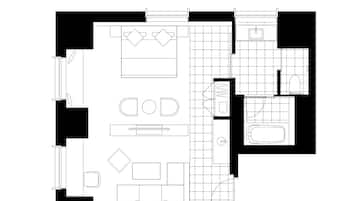 A floor plan with a living area, kitchen, bathroom, and a small balcony.