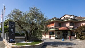 A hotel entrance with a sign reading "Hotel La Villa," a paved driveway, and a tree in the foreground. - La Villa, Sure Hotel Collection by Best Western (Ivrea)