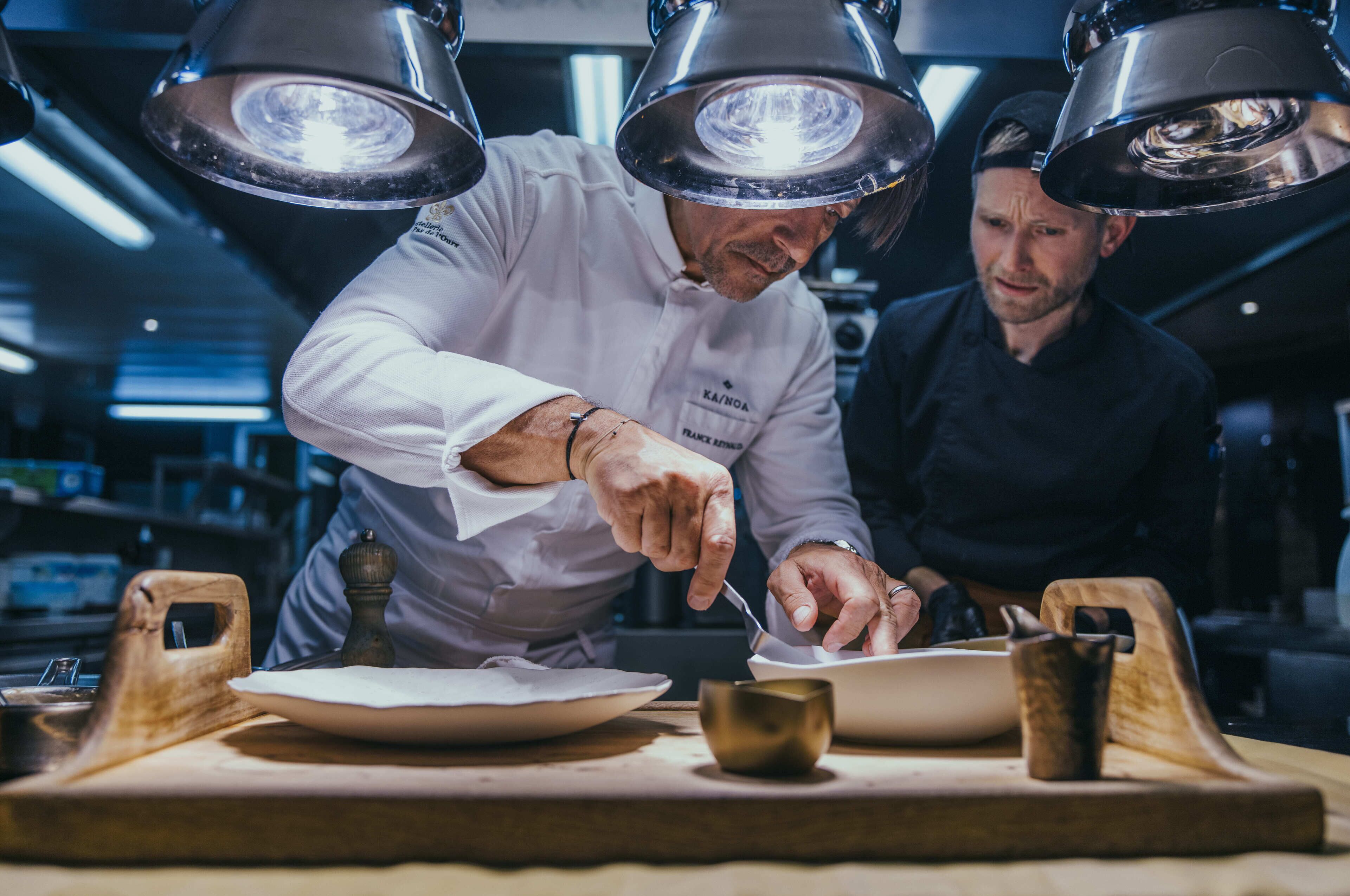 A chef preparing food with a focus on the cooking process.