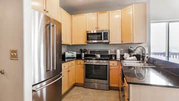 2-Bedroom Condominium #301A | Private kitchen | Fridge, microwave, oven, stovetop