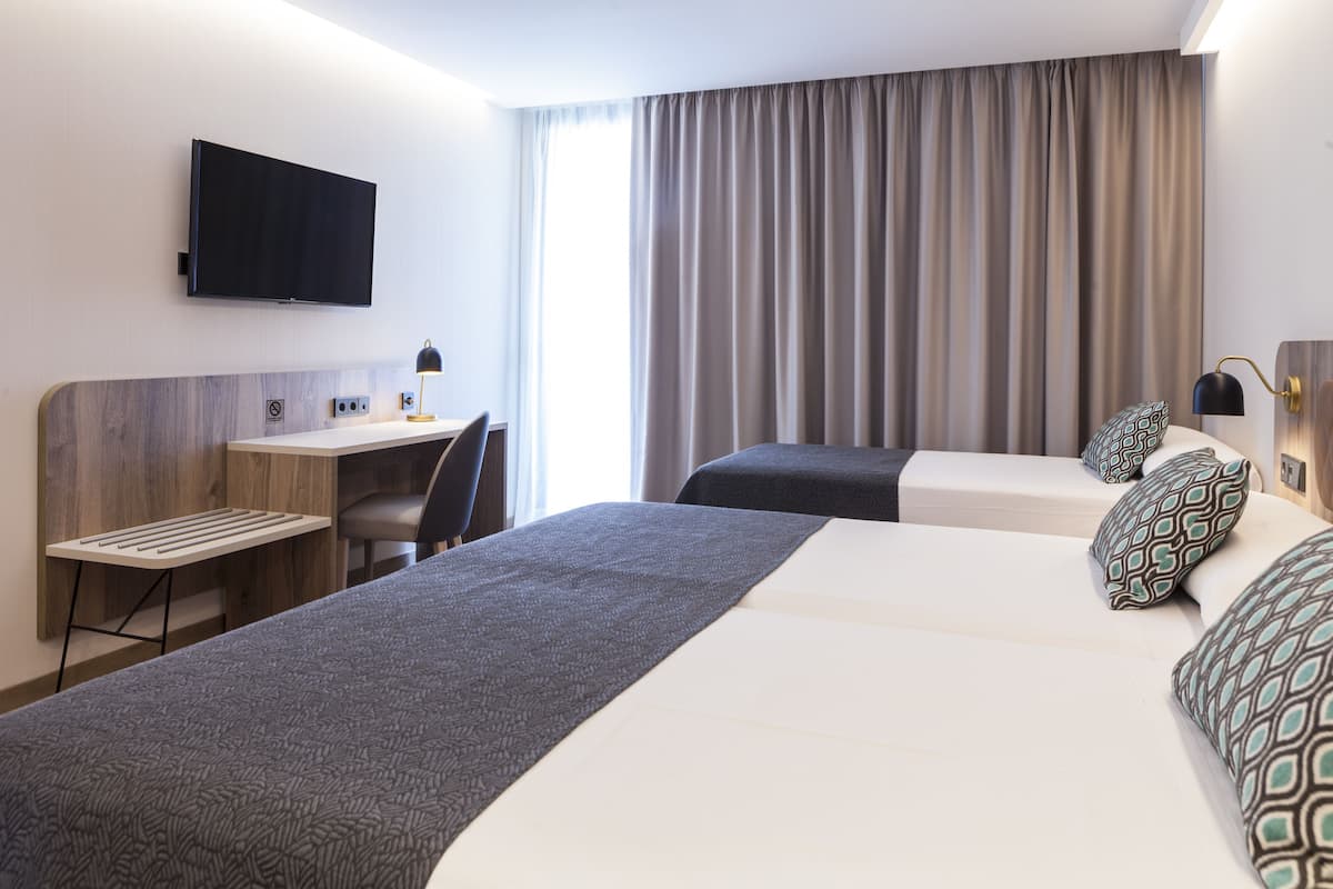 standard triple room, balcony, city view | minibar, desk, laptop workspace, blackout curtains