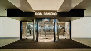 A revolving door entrance to a building labeled "DON PANCHO." - Don Pancho (Benidorm)