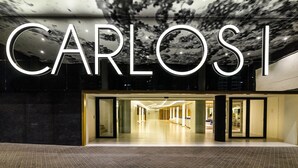 A modern building facade with the name 'CARLOS' prominently displayed in large letters. - Hotel Carlos l (Benidorm)