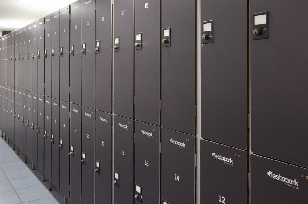 A row of grey lockers with numbers and the "FiestaPark" logo, indicating a locker room area.