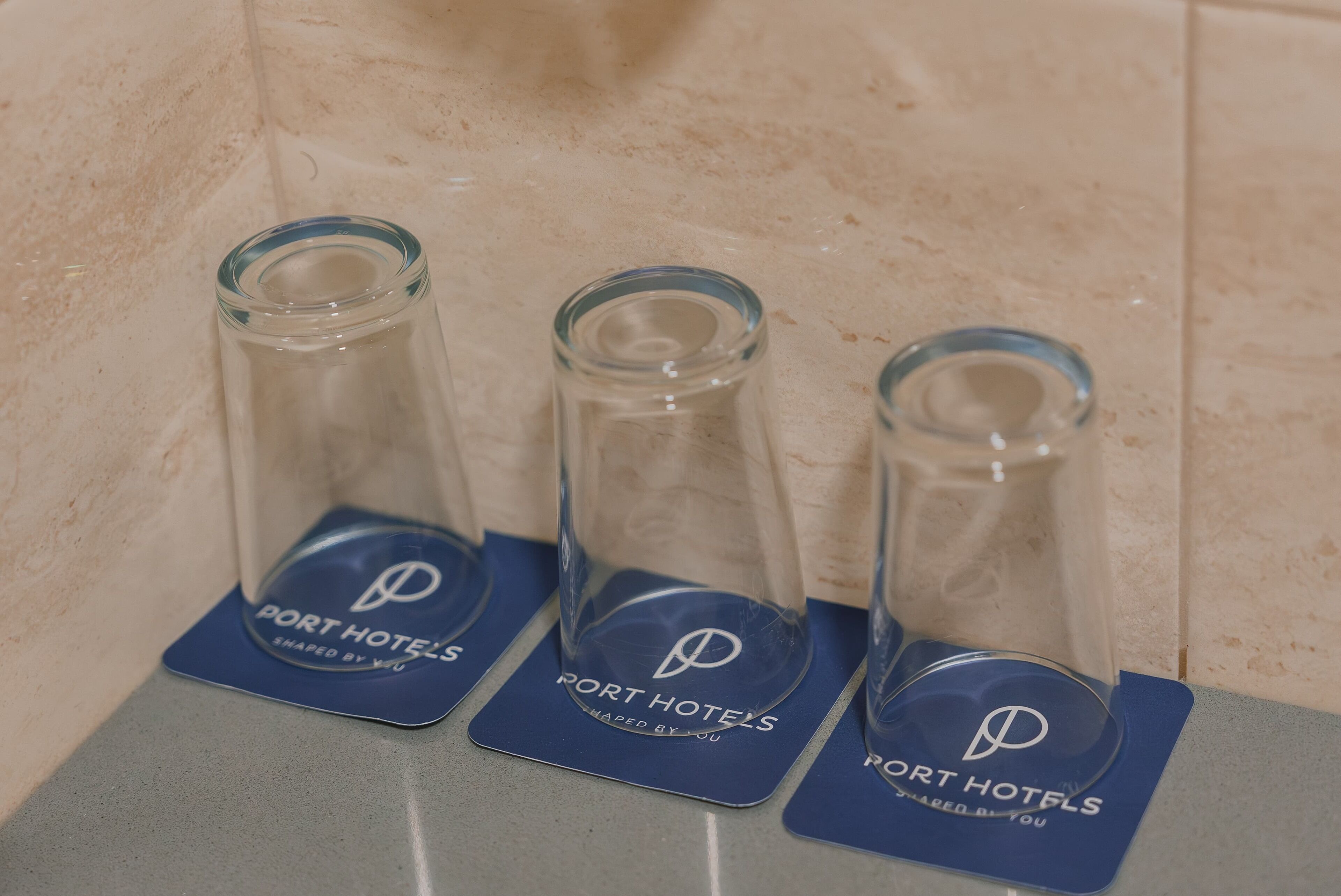 Three glass bottles with labels on a countertop.