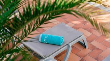 A small table with a towel and a water bottle on it.