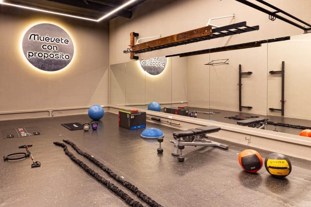 A gym with exercise equipment, a mirror, and motivational wall art.