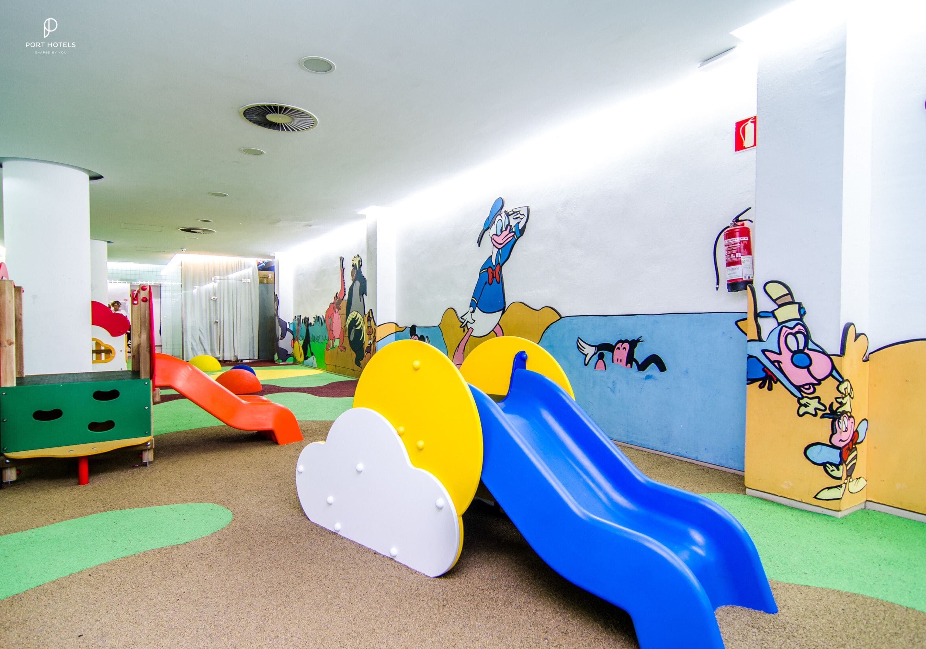 A children's play area with slides and colorful play structures.
