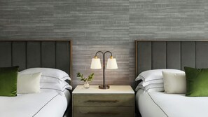 A hotel room with two beds, a nightstand with a lamp, and a textured wall. - Kimpton Marlowe Hotel by IHG (Cambridge)