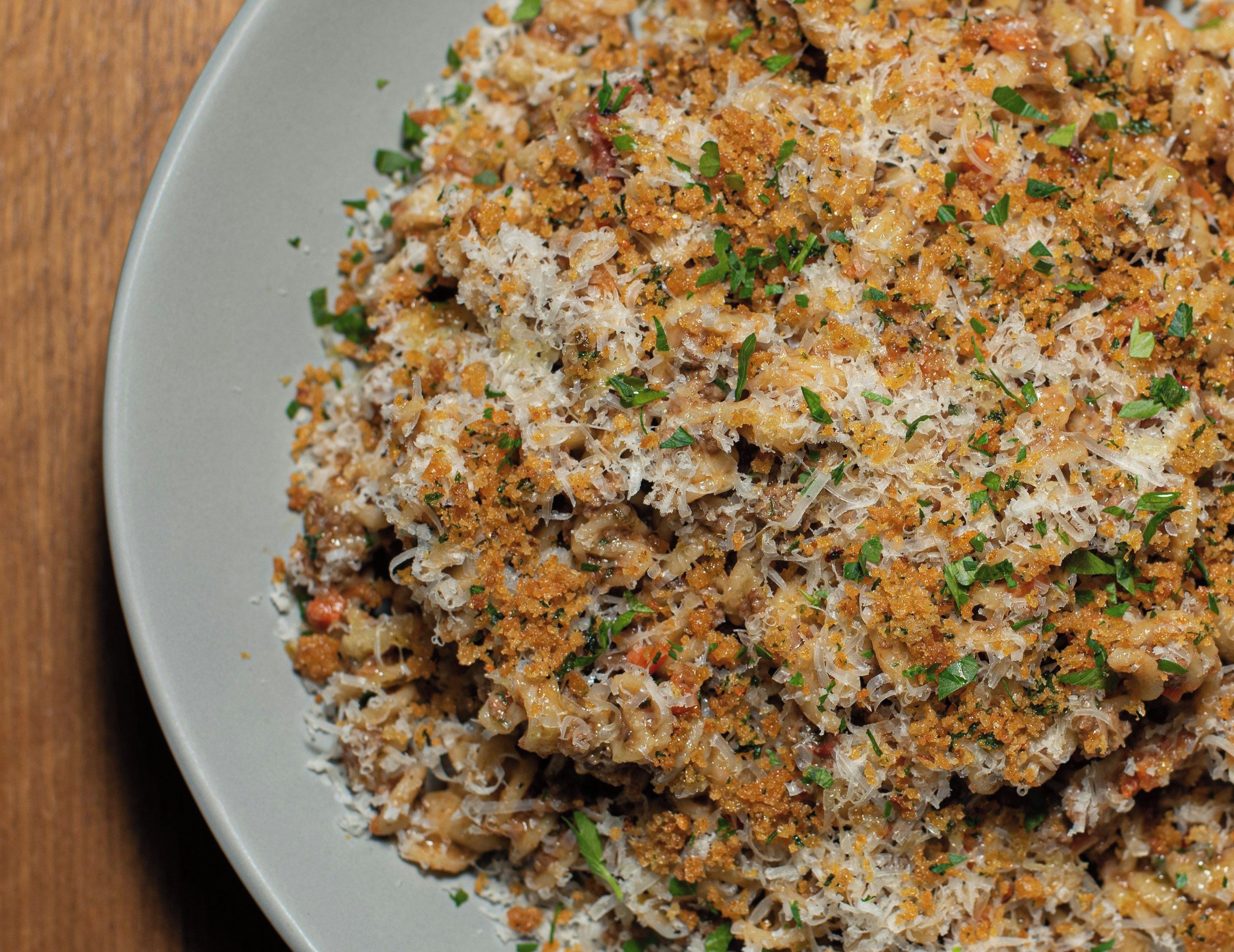 A plate of food with shredded ingredients and a garnish.