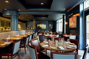 A restaurant interior with multiple dining tables, chairs, and a bar area. - Kimpton Marlowe Hotel by IHG (Cambridge)