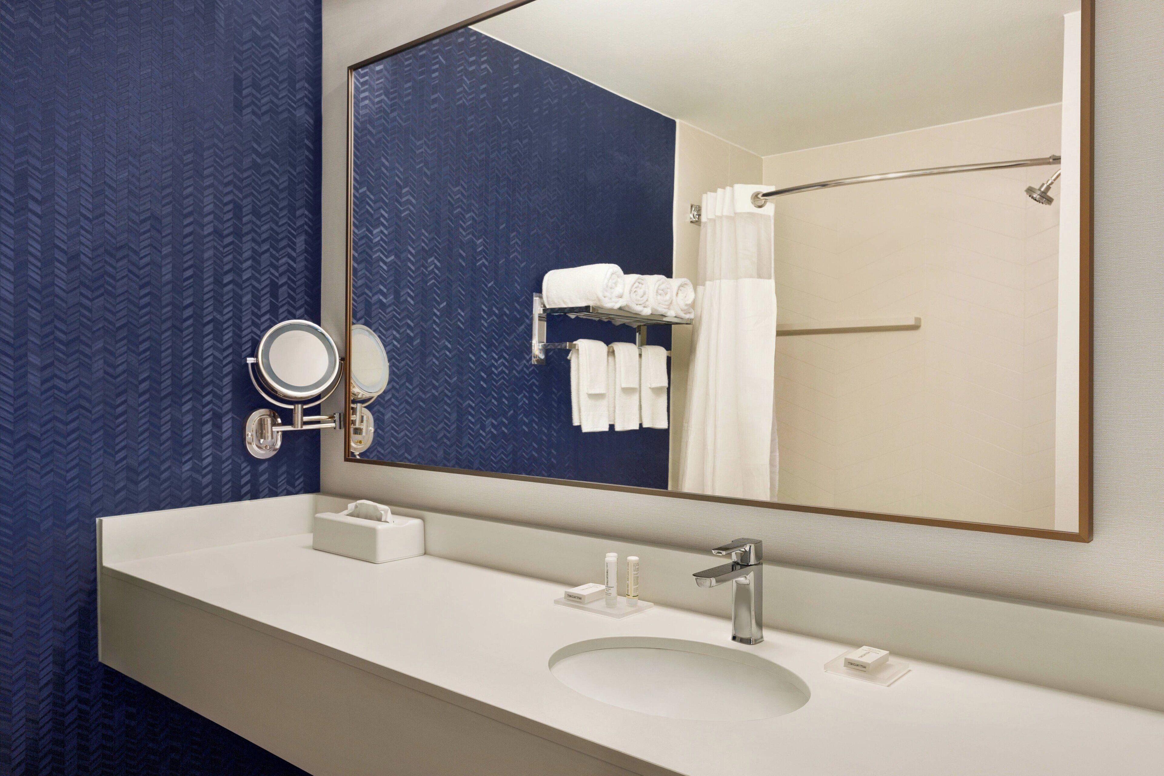 rainfall showerhead, designer toiletries, hair dryer, towels