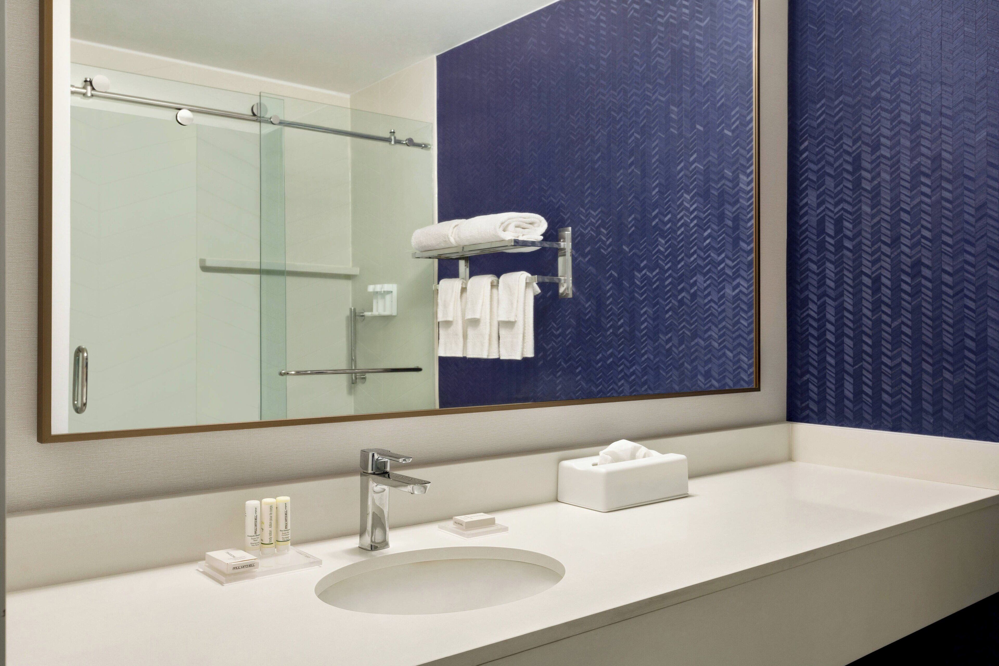 rainfall showerhead, designer toiletries, hair dryer, towels