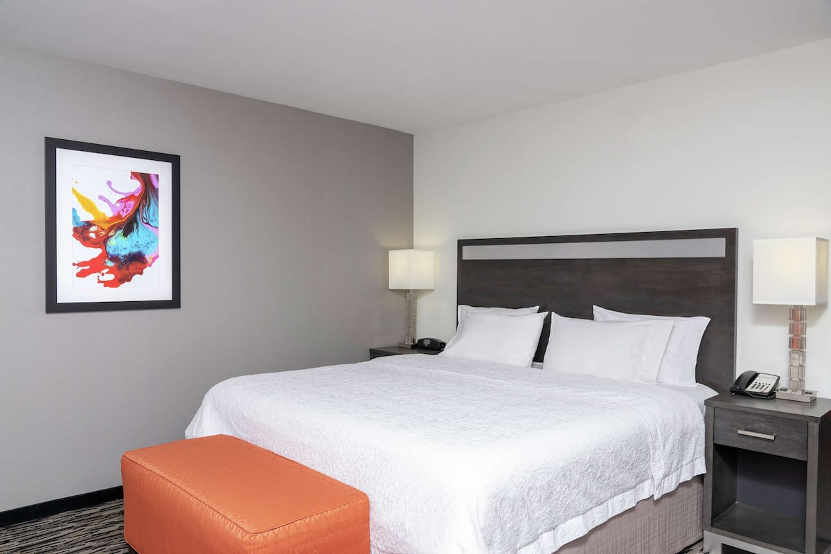 Premium bedding, laptop workspace, iron/ironing board