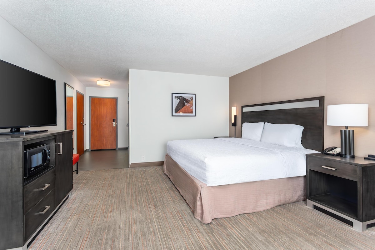Premium bedding, laptop workspace, iron/ironing board