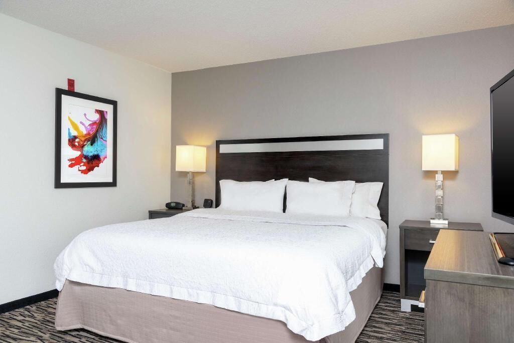 Premium bedding, laptop workspace, iron/ironing board