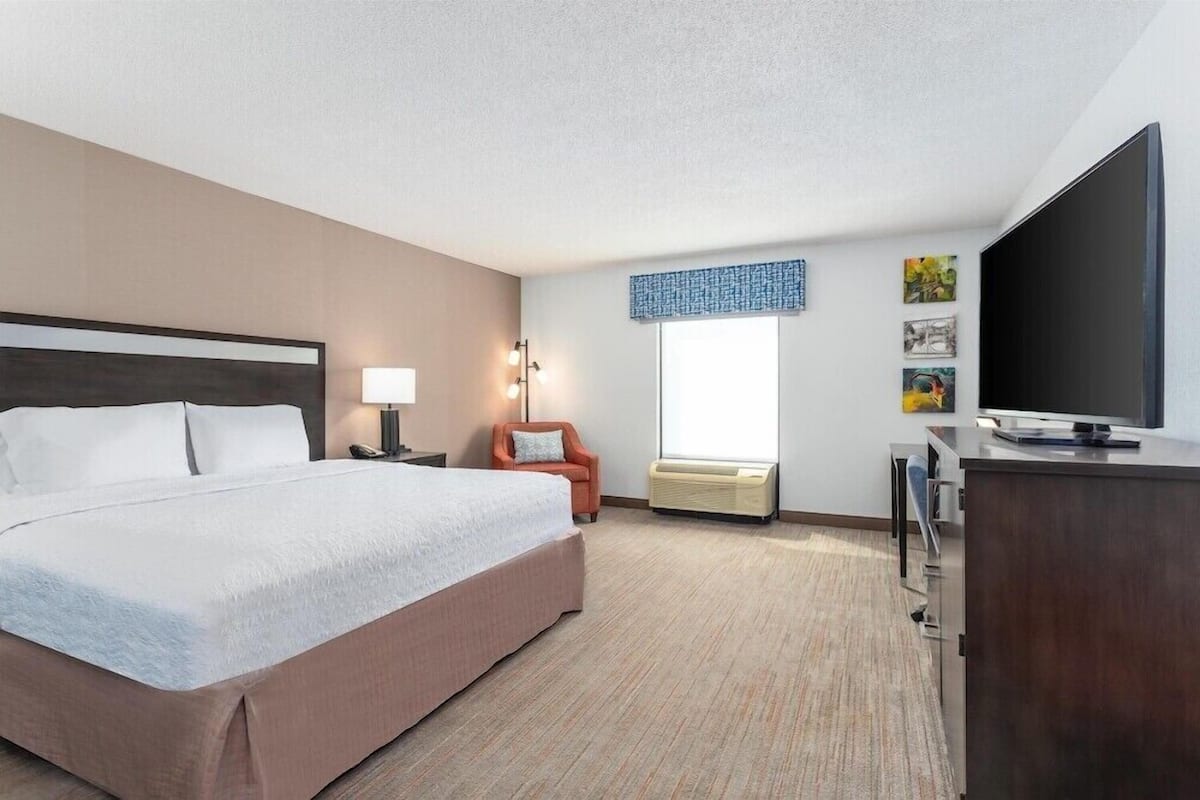 Premium bedding, laptop workspace, iron/ironing board