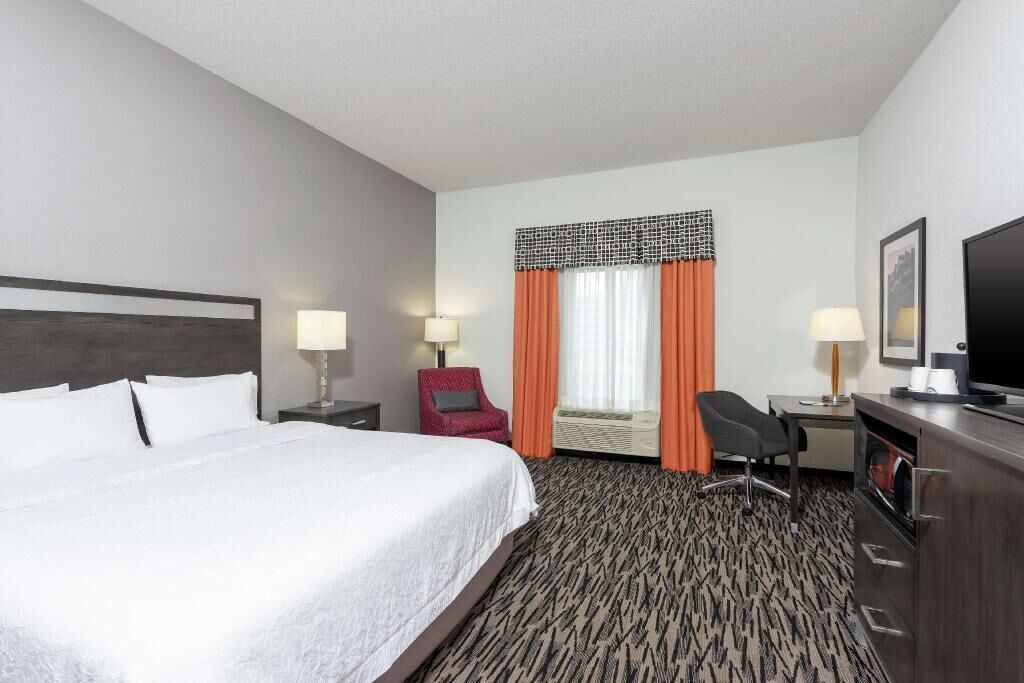 Premium bedding, laptop workspace, iron/ironing board