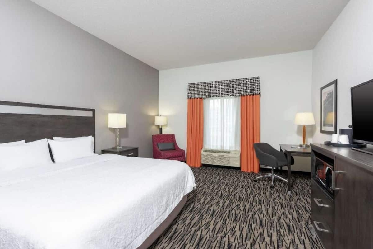 Premium bedding, laptop workspace, iron/ironing board