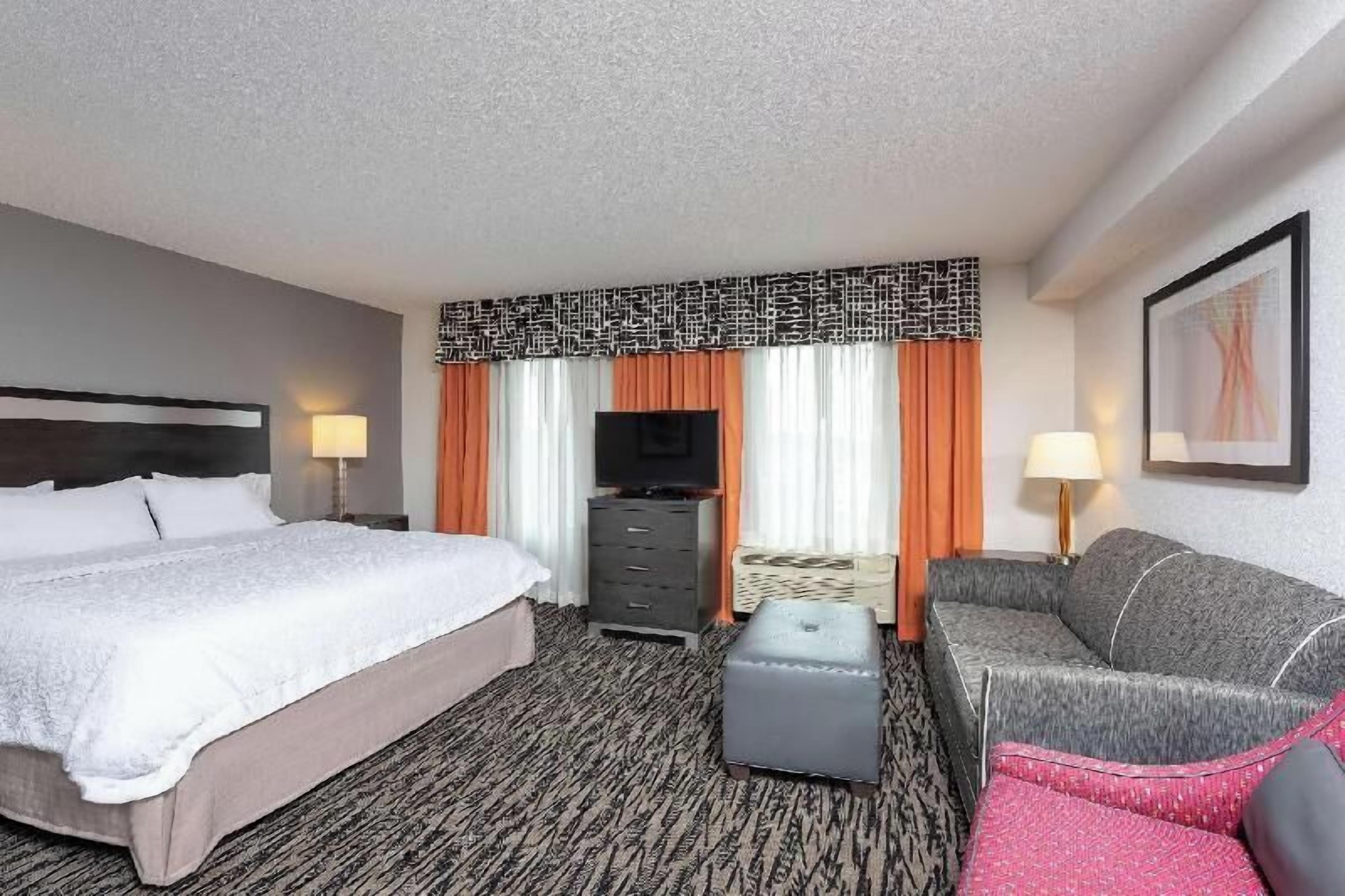 Premium bedding, laptop workspace, iron/ironing board