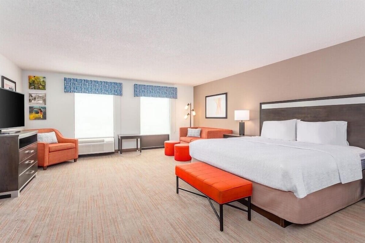 Premium bedding, laptop workspace, iron/ironing board