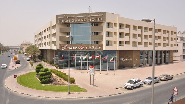 The Dubai Grand Hotel with a modern facade, multiple floors, and a prominent entrance. - Dubai Grand Hotel by Fortune (Dubai)