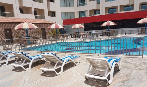 Outdoor pool, open 9:00 AM to 7:00 PM, pool umbrellas, pool loungers