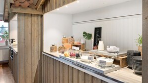 A breakfast bar with various food items and a milk dispenser. - Best Western Vrigstad Vardshus (Vrigstad)