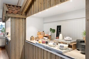 Enjoy a convenient breakfast at our self-service bar, featuring a variety of food and drink options.