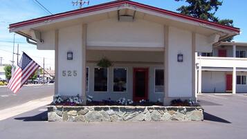 A building with a red roof, a stone foundation, and a number '525' on the front.