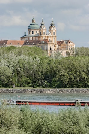 A historic building with domed architecture and two towers, located near a body of water.
