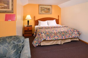 Cozy retreat with a single bed, bedside table, and comfortable chair.